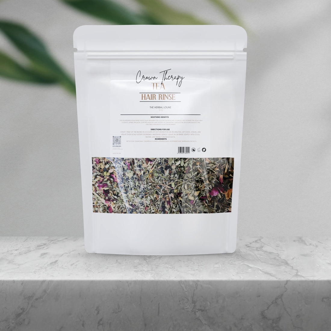 Crown Therapy Tea Rinse botanical hair wellness blend displayed on a clean marble surface